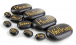 A group of black stones with words written on them.